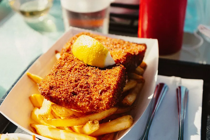 Battered fish and chips in a tray